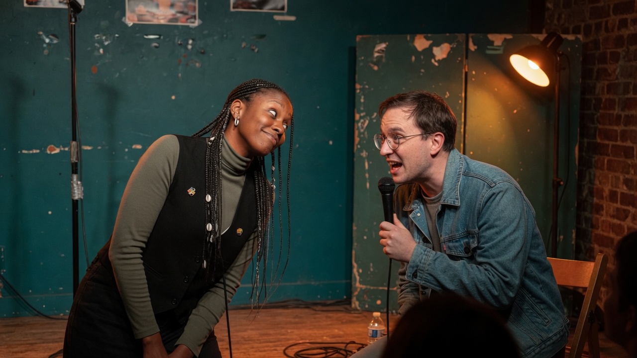 The same fictional pair a moment later, with the microphone in the second performer's hand